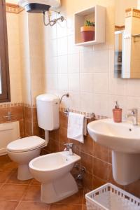 a bathroom with a toilet and a sink at MrBrown - Cinzia Resort Beach in Mazara del Vallo