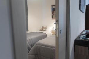 a small room with two beds and a window at MrBrown - Cinzia Resort Beach in Mazara del Vallo