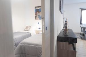 a bedroom with a bed and a table in a room at MrBrown - Cinzia Resort Beach in Mazara del Vallo