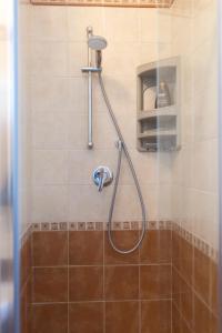 a shower with a hose in a bathroom at MrBrown - Cinzia Resort Beach in Mazara del Vallo