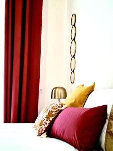 a bedroom with a bed with red and yellow pillows at I Sogni della Regina in Sorrento