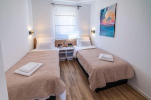 Łóżko lub łóżka w pokoju w obiekcie PINNA RESIDENCE - Supin