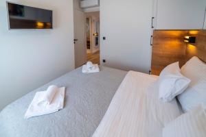 Łóżko lub łóżka w pokoju w obiekcie PINNA RESIDENCE - Supin