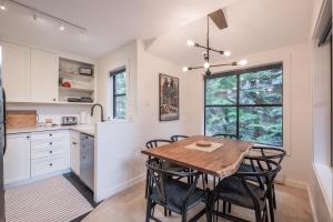 a kitchen with a wooden table and chairs at Powderview 24 by Outpost Whistler in Whistler