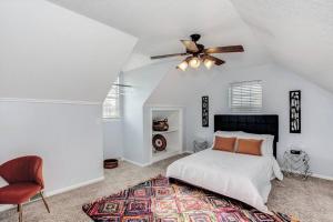 a bedroom with a bed and a ceiling fan at WOW! Spacious Retreat & amazing yard 2400+4bd/3bth in Wichita
