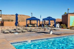 a swimming pool with chairs and a gazebo at Resort Villa 4 - LUXURY VILLA, POOL VIEW, GAMES GALORE, TOP LEVEL! YEAR ROUND HEATED POOL & HOT TUB! in St. George