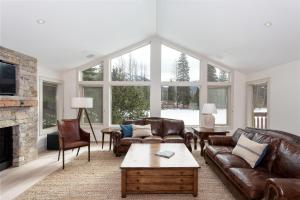 a living room with leather furniture and a fireplace at 8166 Nicklaus North in Whistler