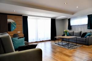 a living room with a couch and a table at Apartament Anna in Bachowice