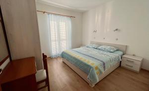 Postel nebo postele na pokoji v ubytování Apartments Villa Emilija
