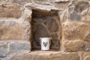 a white cup sitting in a stone wall at Boutique House Rustikana by Locap Group in Izola