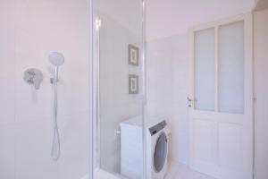 a white bathroom with a shower and a toilet at Right House via Sulis 23 - Best Neighborhood in Town in Cagliari +13 photos
