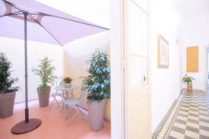 a balcony with potted plants and a table at Right House via Sulis 23 - Best Neighborhood in Town in Cagliari