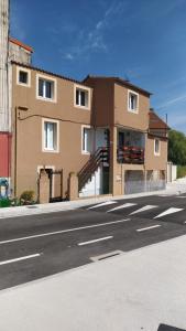 a large building on the side of a street at La Casucha junto al mar in Vilagarcia de Arousa