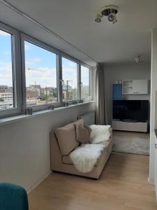 a living room with a couch and some windows at Appartement mit Penthaus Charakter in Fürth