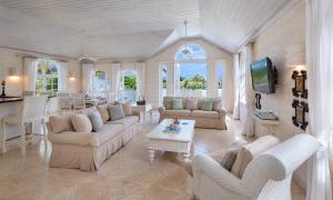 a large living room with couches and a table at Royal Villa 19 in Saint James