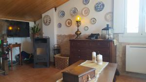 a living room with a dresser and plates on the wall at La Casucha junto al mar in Vilagarcia de Arousa