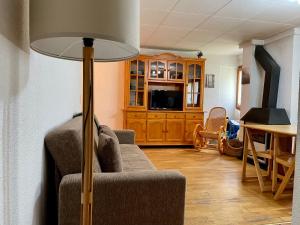 a living room with a couch and a table at Apartamento LA MOLINA in Alp