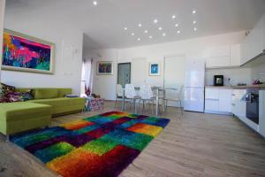 a living room with a couch and a colorful rug at Boutique Villa Nirvana 2, Proboj 25 in Pag