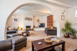 an archway in a living room with furniture and a fireplace at Riverside in Ullapool