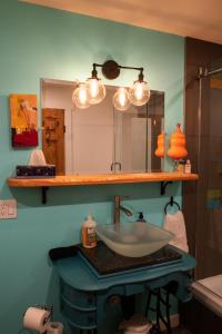 a bathroom with a sink and a mirror at Gallery Suite art-cation vacation! in Nelson