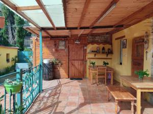 a patio with a wooden door and a table at EL PINAR DE BARDENA in Carcastillo