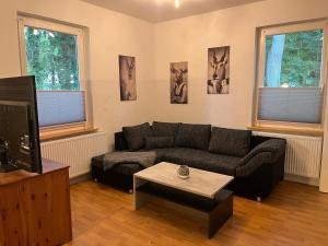 a living room with a couch and a coffee table at Diershof Walsrode in Walsrode