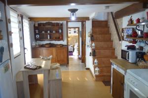 a kitchen with a table and a counter in it at Casita con olor a mar A CASUCHA in Vilagarcia de Arousa