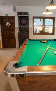 a pool table in a living room with a pool table at Fazekasház in Nagykáta