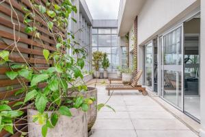 an internal courtyard of a building with plants at Trend Nova Carlos Gomes - 406 in Porto Alegre