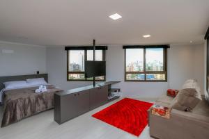 a bedroom with a bed and a red rug at Paseo Del Molino - 703 in Caxias do Sul