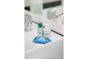a bathroom counter with two bottles of soap and a sink at Paseo Del Molino - 703 in Caxias do Sul +30 photos