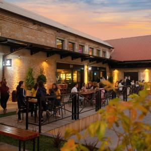 a group of people sitting at tables outside a restaurant at Paseo Del Molino - 703 in Caxias do Sul