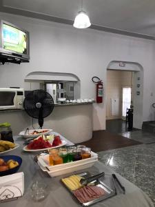 a kitchen with a table with food on it at HOTEL BELA VISTA NOVA ODESSA in Nova Odessa