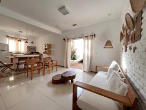 a living room with a couch and a table at Villa Mar Residence in Jericoacoara