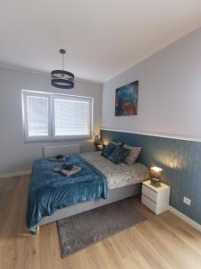 Łóżko lub łóżka w pokoju w obiekcie Chcę tu zostać Apartamenty Gdynia