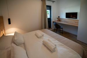 Posteľ alebo postele v izbe v ubytovaní PINNA RESIDENCE - Caretta