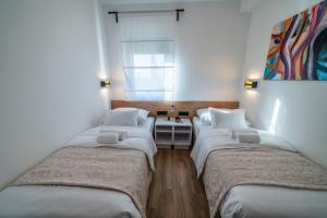 Posteľ alebo postele v izbe v ubytovaní PINNA RESIDENCE - Caretta