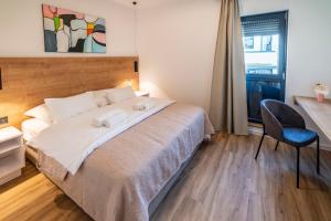 Posteľ alebo postele v izbe v ubytovaní PINNA RESIDENCE - Caretta