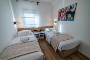Posteľ alebo postele v izbe v ubytovaní PINNA RESIDENCE - Caretta