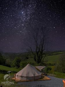 a tent under a star filled night sky at Herons Retreat in Llandysul