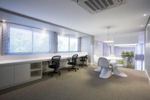 an office with a desk and chairs and a table at Trend NCG - Apartament 1602 in Porto Alegre +23 photos