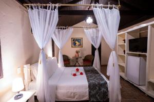 Postel nebo postele na pokoji v ubytování Pousada Villa das Pedras + 37 fotografií