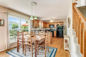 a kitchen and dining room with a table and chairs at Compass Rose II in Folly Beach +23 photos