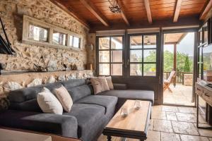 a living room with a couch and a table at Fameliti Casa Torre - Historic Maniot Tower House in Stavríon