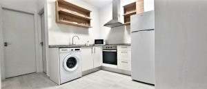 a kitchen with a washing machine and a refrigerator at Cardón Jandía 1A in Morro del Jable