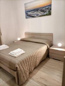 a bedroom with a large bed with two night stands at Casa Vergara Piazza Mazzini in Lecce