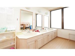 a bathroom with two sinks and two mirrors at Famy Inn Makuhari - Vacation STAY 16040v in Chiba