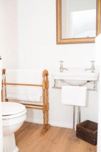 a bathroom with a toilet and a sink at Drift View Shepherds Hut in Melton Mowbray