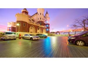 a large building with cars parked in a parking lot at Famy Inn Makuhari - Vacation STAY 16033v in Chiba