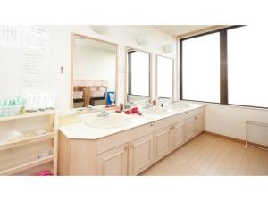 a bathroom with two sinks and two mirrors at Famy Inn Makuhari - Vacation STAY 16043v in Chiba
